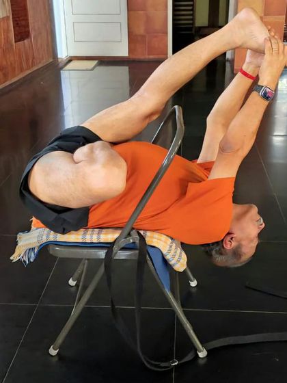 A deep backbend over a chair.