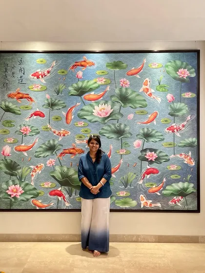 Standing proudly with the 10x9 ft Koi Fish pond mural I designed for the High Commission of Singapore. This piece brings tranquility and color to the embassy in New Delhi.