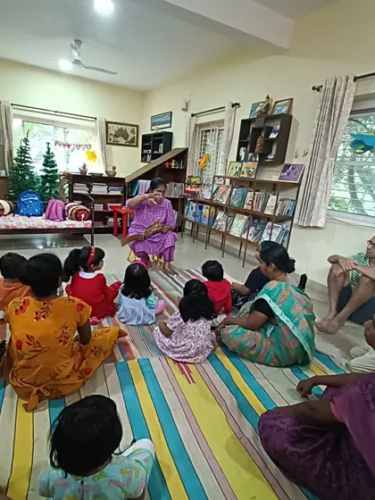 This view shows parents sitting alongside their children, modeling engaged listening.
