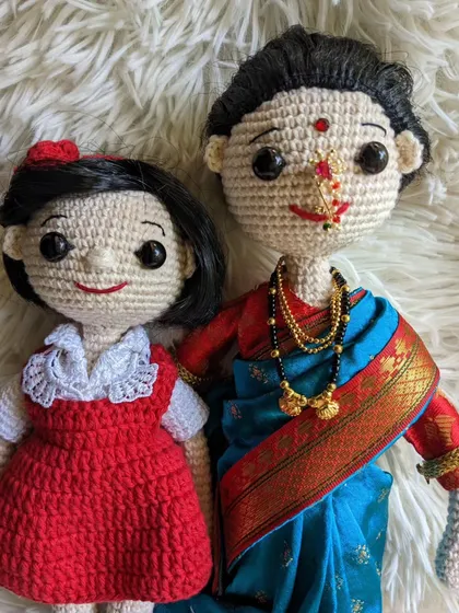 A closer look at the mother-daughter custom doll set, showing the connection between the two figures.