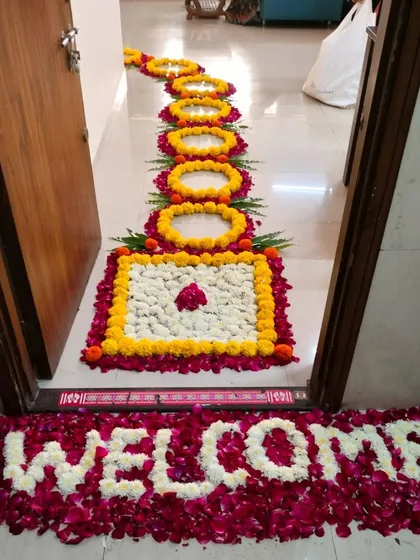 A welcoming floral arrangement at the doorstep. We used fresh rose and jasmine petals to write the word 'Welcome', followed by a traditional floral rangoli pathway to greet guests.