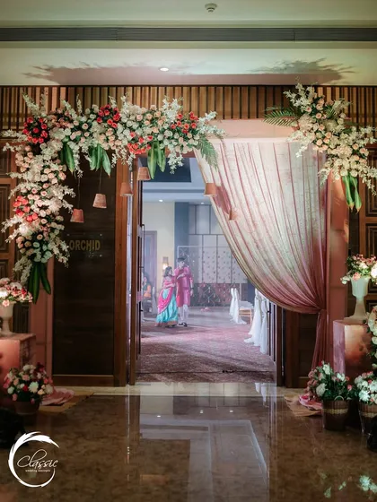 Even a simple doorway can be transformed into a grand entrance. Here, I used a lush floral arch with pink and white blooms to frame the entry, offering a peek into the celebration inside.