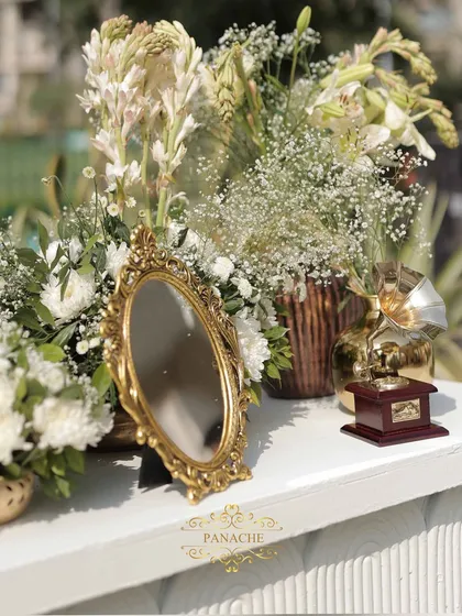 A detail shot of the welcome console, featuring a vintage-style mirror and a miniature gramophone prop.