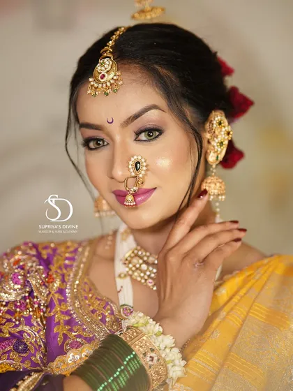 A captivating close-up of a Marathi bride. Her expressive eyes, accentuated with liner and a classic bindi, along with the traditional nose ring, make for a powerful and beautiful image.