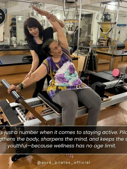 Wellness has no age limit. Here, I am assisting one of our senior clients with a gentle stretch on the reformer. Pilates strengthens the body, sharpens the mind, and keeps the spirit youthful, no matter how old you are.