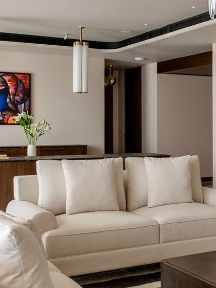 This shot highlights the open-plan nature of the Parishram residence, with a clear line of sight from the living room through to the dining area and beyond.