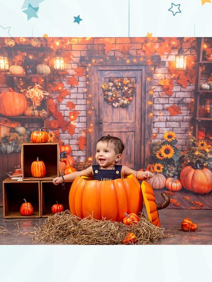 A wide shot of the cozy and inviting pumpkin patch setup. The warm lighting and autumn colors create a magical atmosphere for this little one.