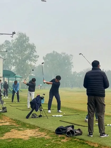 A coach watches over a group of players on a foggy day, providing guidance and support.