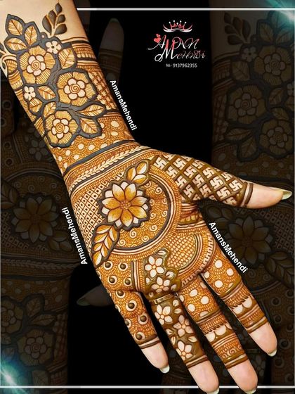 A vibrant floral design for the back of the hand. The central mandala is surrounded by swastika patterns, a symbol of good fortune, and the wrist has a dense floral band.