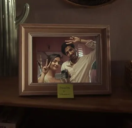 A final, heartwarming shot from the film, showing a framed photo of the couple. This single image encapsulates the story of love and memories that we aimed to tell through our creative direction and styling.