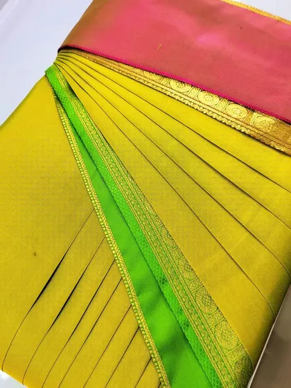 The neat finishing on this pre-pleated yellow and green silk saree makes it a great choice for any celebration. Just open, drape, and go.