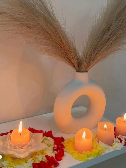 My white lotus T-light holder styled as part of a beautiful Diwali decor setup. It looks so serene surrounded by flower petals and other candles.