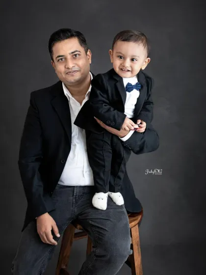 Like father, like son. This dapper duo looks so sharp in their matching formal wear against my classic dark grey backdrop.