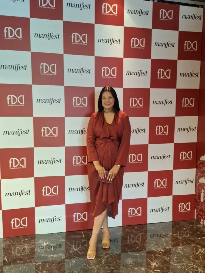 My look for the FDCI Wedding Weekend. This draped rust-colored dress offers a comfortable yet chic alternative to traditional wedding wear, perfect for a day of exploring designer collections.