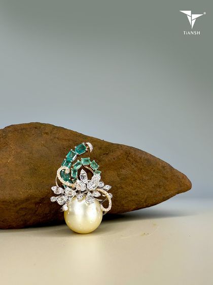 A pearl born of the ocean, emeralds shaped by the earth, and diamonds kissed by light. This brooch whispers a story only nature could write.