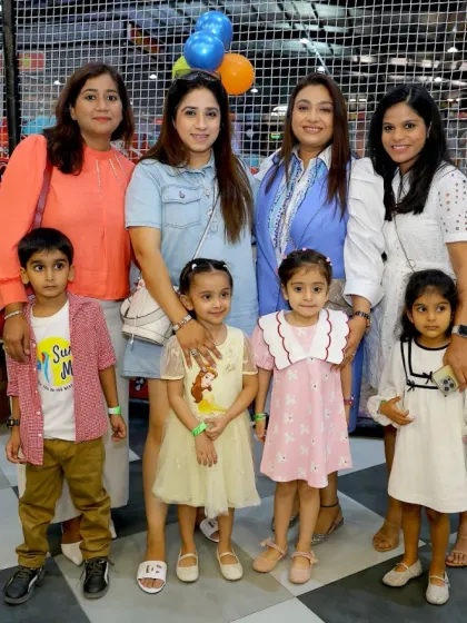 A group of moms and their kids enjoying a day out at Wobble World. It's a place for both kids' fun and parents' social time.