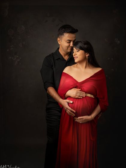 A dramatic and passionate couple's portrait. The deep red and dark tones create a moody and romantic atmosphere.