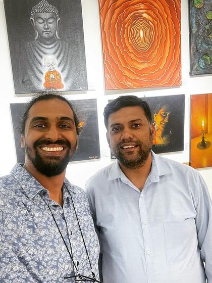 With a fellow artist at the exhibition.