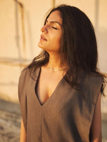 An outdoor, rooftop session with Rashmi Som during sunset. This close-up captures the warm, golden light on her face.