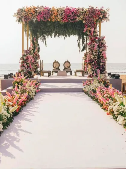 Imagine saying 'I do' with the ocean as your witness. I design breathtaking beachside ceremonies, like this one in Goa, complete with a lush floral mandap and an elegant aisle, ensuring your seaside wedding is as serene and beautiful as the setting itself.