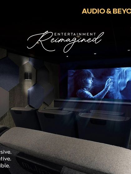 Entertainment, reimagined. This is our vision for an immersive, innovative, and incredible home cinema, featuring acoustically treated walls with hexagonal panels, comfortable tiered seating, and a perfectly calibrated screen for a truly cinematic feel.