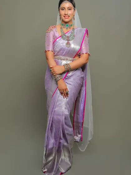 A full-length view of the lavender saree, its shimmering silver zari and pink border creating a modern and elegant look.
