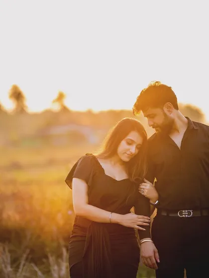 A quiet moment of comfort in a sunlit field. The way she rests her head on his arm speaks volumes about trust and finding peace in each other's presence.