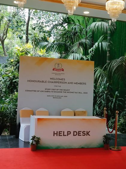 A close-up of the branded help desk and backdrop at a government event. Our setups ensure that every functional element, like a registration desk, is professionally presented.