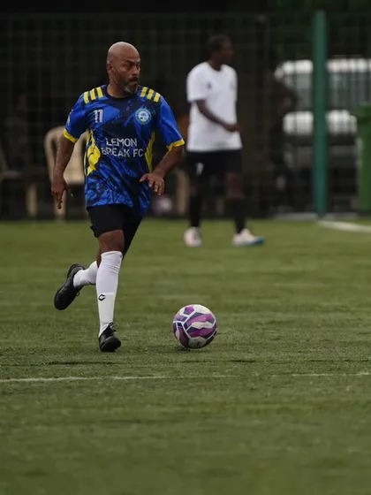 One of our veteran players skillfully controls the ball and advances up the pitch. Our team is built on experienced players who still have the drive and technique to compete at a high level.