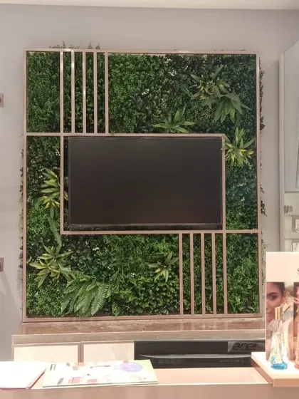 Another view of the artificial green wall at the Biba showroom, showing its placement behind the checkout counter.