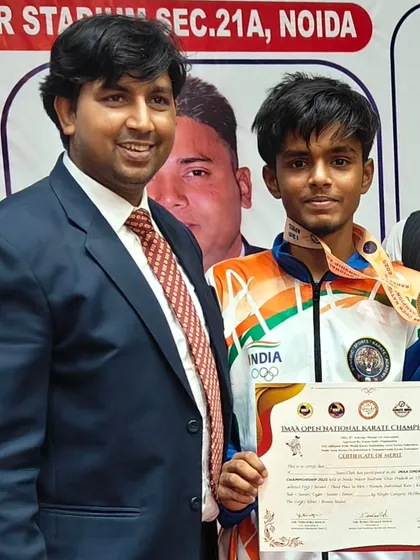 A proud student with his gold medal and certificate at the DDAA Open National Karate Championship. His hard work in kumite and kata training paid off.
