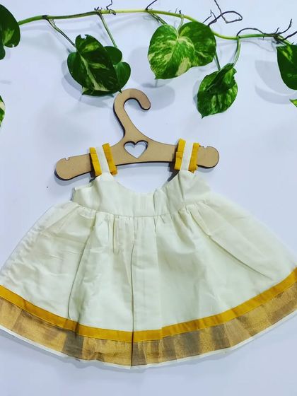 Another version of my Kasavu dress, this time with yellow handloom detailing on the straps. It's a simple, timeless dress perfect for celebrating our traditions.