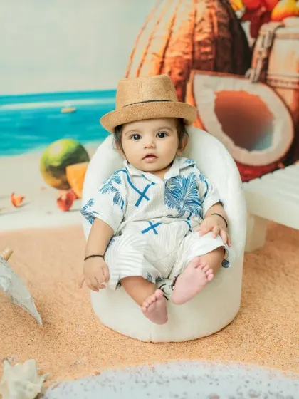 This little man is ready for his beach day! This 4-month-old is styled in a cool Hawaiian shirt and hat, showing how I customize the 'Beach Baby' theme for boys.