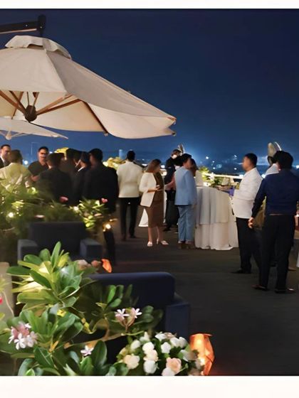 Another view of the rooftop event, showing guests enjoying the ambiance we created with thoughtful lighting and placement of seating areas.