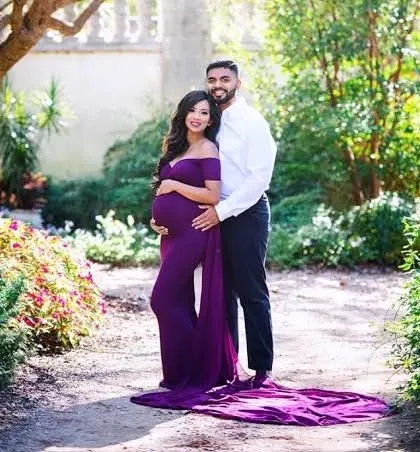 A glamorous maternity photo of a couple in a beautiful garden. We can create elegant and styled portraits to celebrate your pregnancy.