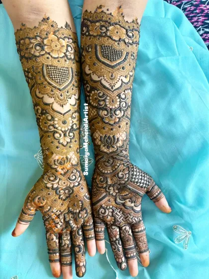 This is the same bridal henna design, showing how the pattern looks from a different angle. The symmetry in the arms creates a really balanced and regal look, perfect for a bride.
