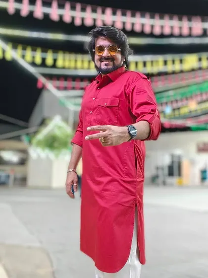 Posing in my red pathani suit before the Navratri performance in Muscat. The festive decorations in the background set the perfect mood.