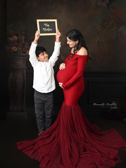 The future big brother proudly announces his new role. Using props like this chalkboard sign adds a personal and fun touch to family maternity sessions.