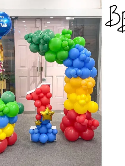 Inspired by the classic colors of Sesame Street, this first birthday setup is bright and cheerful. The number '1' mosaic is paired with a primary color balloon arch, creating a perfect photo opportunity for a little one's big day.