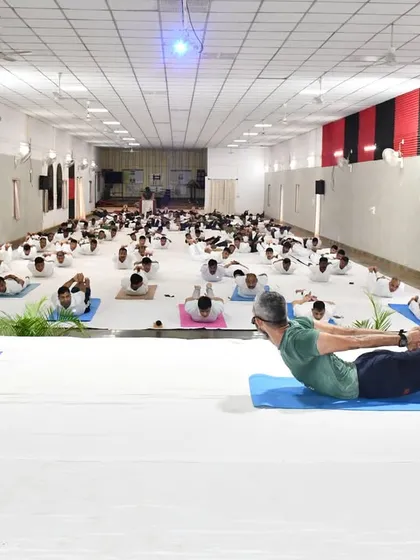 Soldiers practicing Salabhasana (Locust Pose), a powerful back-strengthening posture. A strong back is essential for the physical demands of their service.