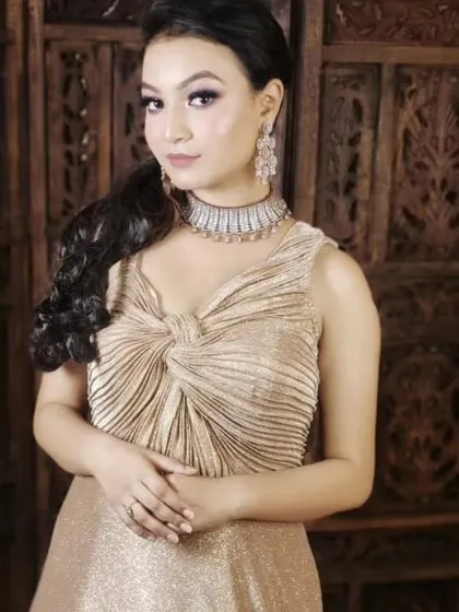 This champagne gold gown with a pleated bodice is both classy and comfortable. It's a versatile piece that works for many different occasions.