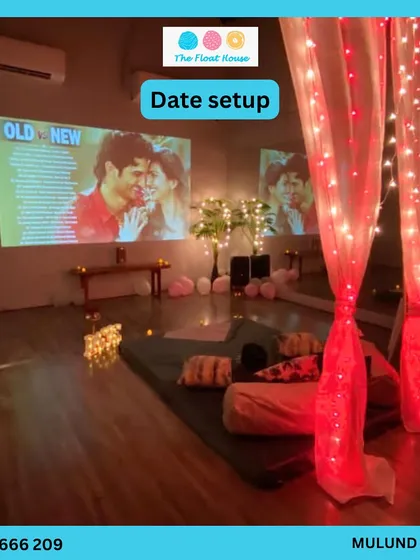 Surprise your loved one with a private date night. We offer custom setups like this cozy movie night with a projector, comfy seating, and romantic lighting in one of our private studios.
