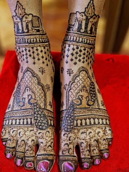 A classic bridal feet design with graceful peacocks on the top of the feet and royal elephants on the ankles.