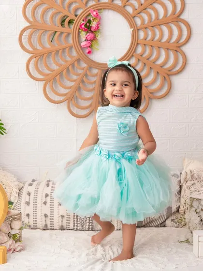 Celebrating two! This happy toddler is enjoying her second birthday shoot in a bright and cheerful setup. I capture milestones at every age.