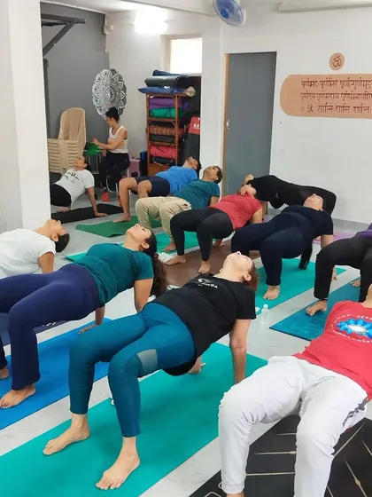 Here, a class works on core and back strength with Purvottanasana, or Reverse Plank. The image shows how the floor space can be fully utilized for mat-based exercises with a full class.