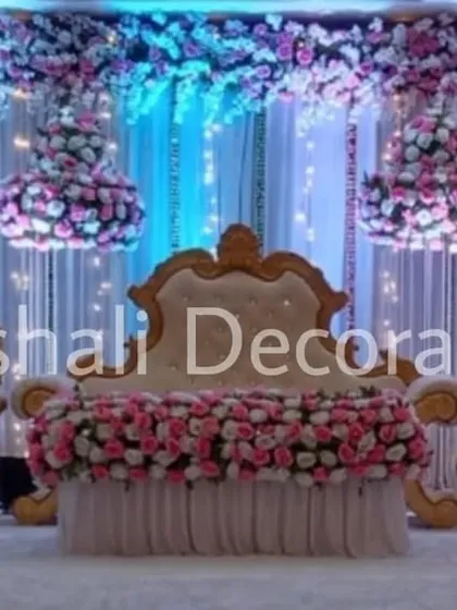 This is a classic and elegant wedding reception stage, always in high demand. The rental package includes the royal throne chair and matching sofas, a backdrop of white drapes with fairy lights, and beautiful hanging floral chandeliers.