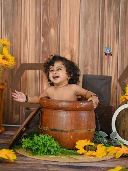 A duplicate of image 185, a joyful baby in a barrel.
