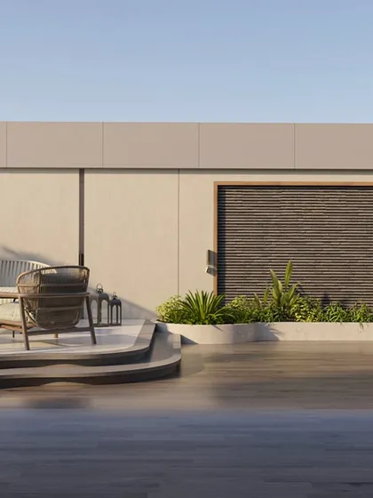 This view shows the different levels and seating areas on the terrace during the day. The design provides a variety of spaces, from the open deck for sunbathing to the shaded lounge for conversation, all surrounded by greenery.