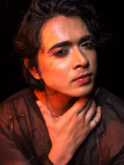 A close-up of the creative male makeup, featuring subtle graphic details and perfectly groomed brows.