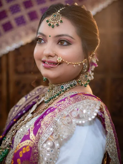 A beautiful portrait of a bride in her traditional Gujarati attire, looking elegant and serene.
